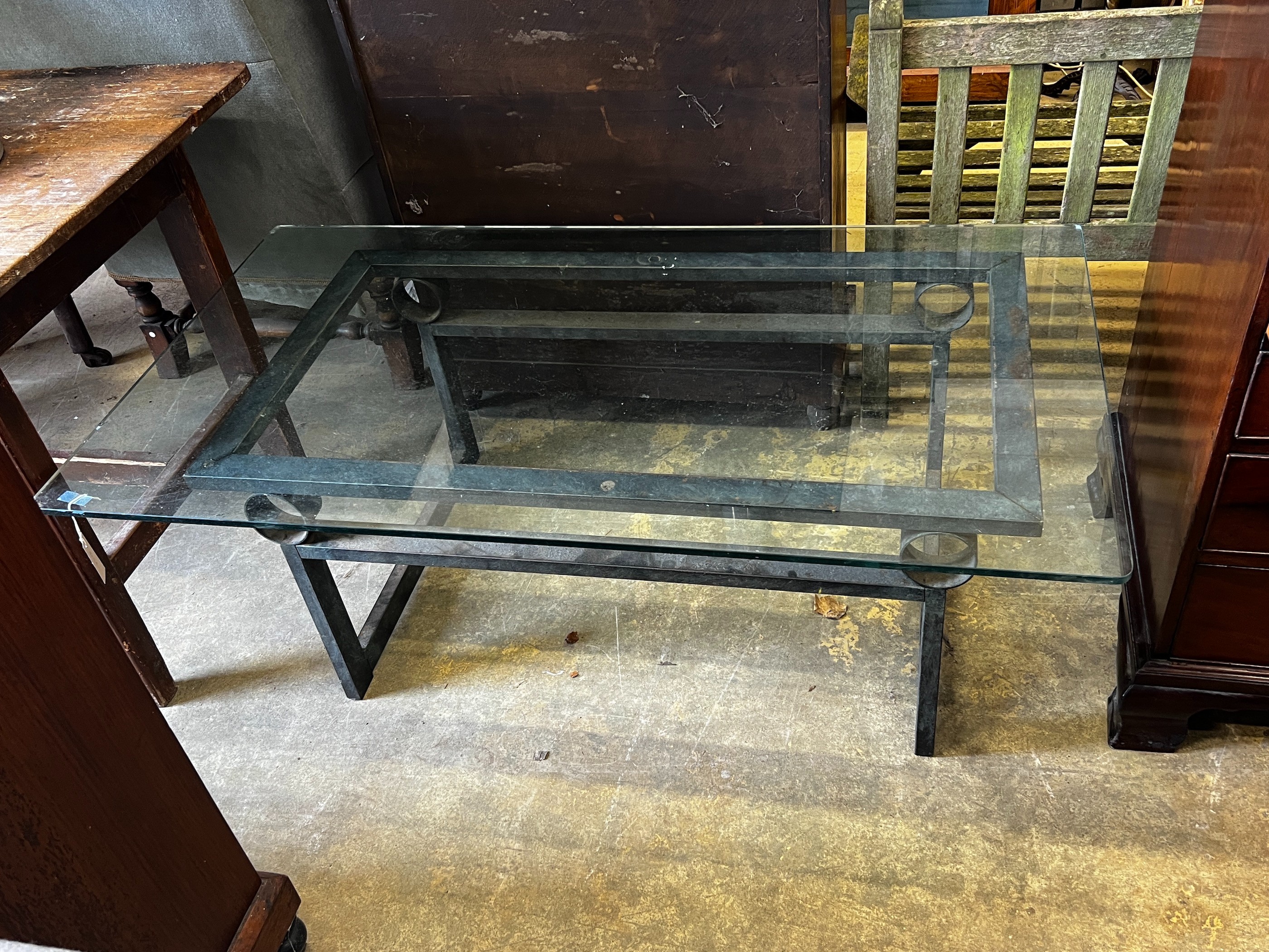 A rectangular glass topped cast metal coffee table, width 137cm, depth 76cm, height 46cm